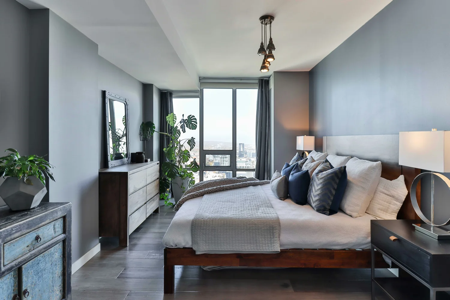Modern furnished bedroom with city view